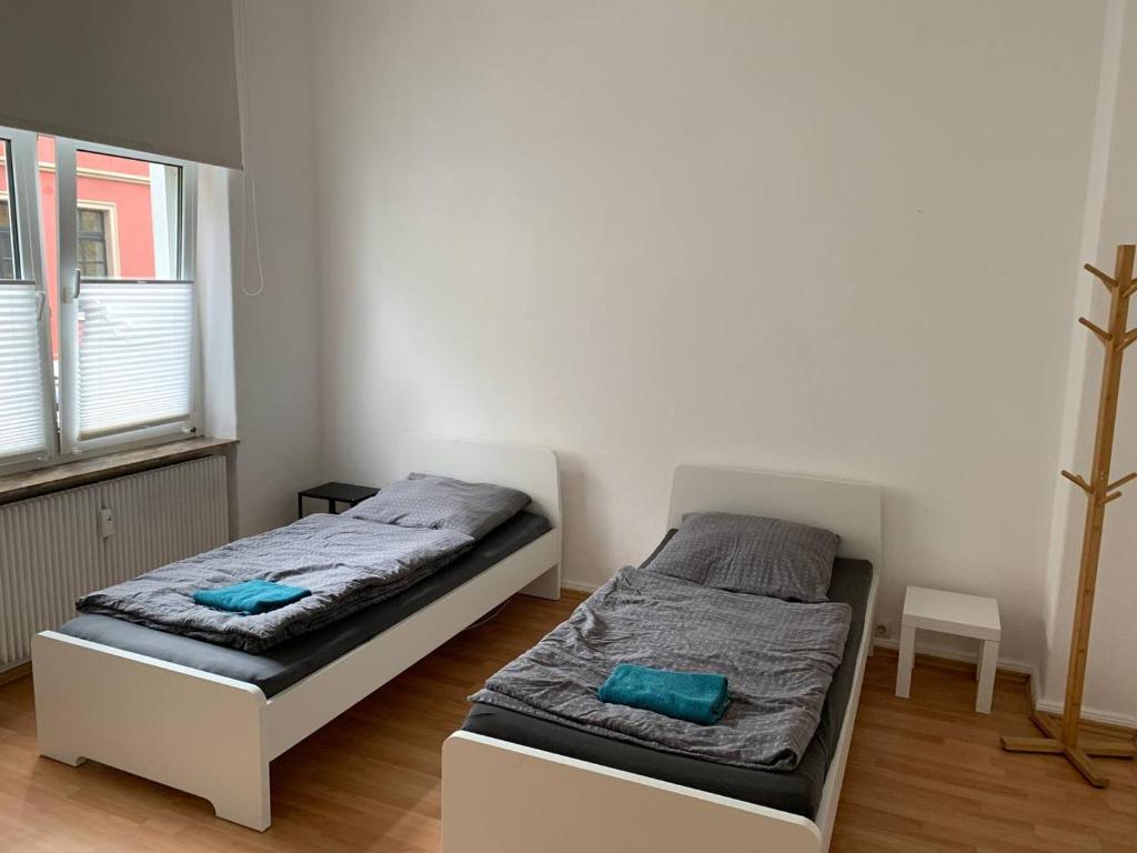 a bedroom with two beds and a window at Gemütliches Apartment in Osnabrück in Osnabrück