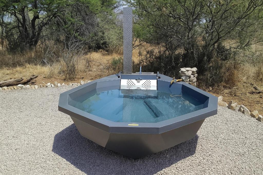 a bath tub sitting on top of a field at Rupping Bush Retreats in Mmukubyane
