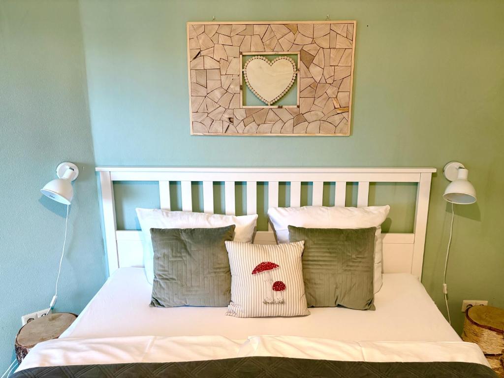 a bedroom with a bed with white sheets and pillows at Fewo Herzgrün nähe Skilift & Loipe mit Sauna im Haus und Traumblick E-Ladestation in Todtnauberg