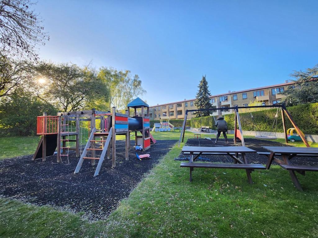 a park with a playground with a slide at Nice home with free parking close to downtown and nature! in Copenhagen