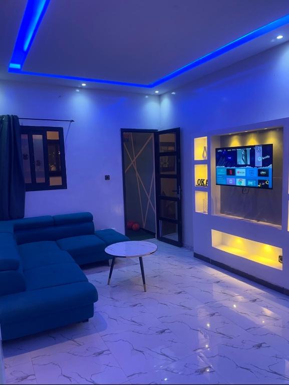 a living room with a couch and a table at Oka in Déni Diarke