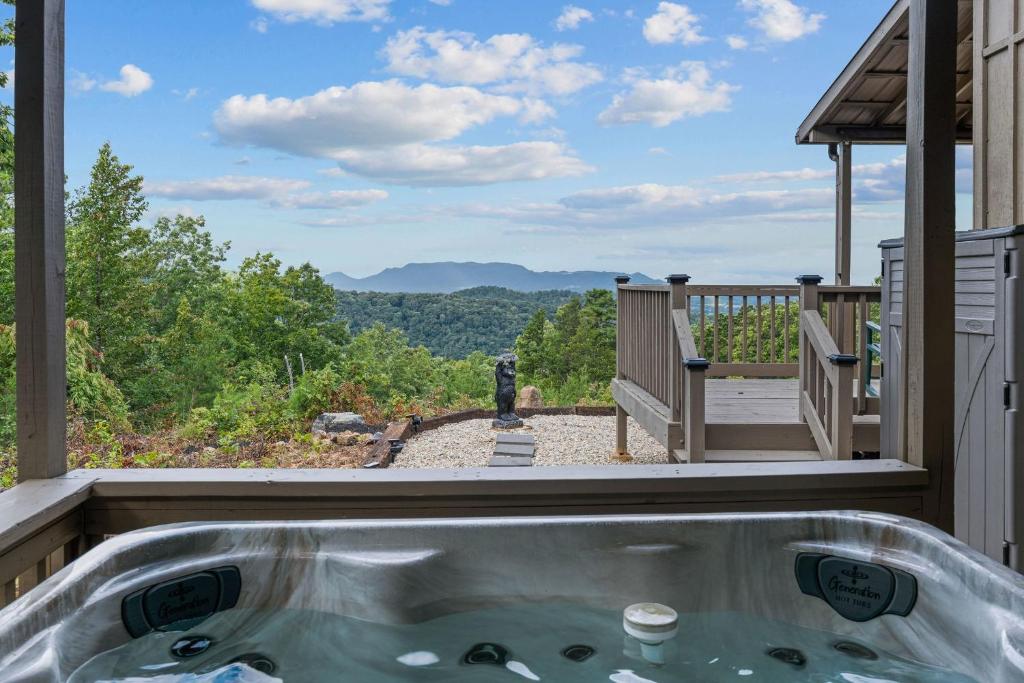 a hot tub on a deck with a view of the mountains at John Wayne View cabin in Del Rio
