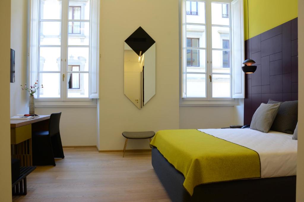 Postel nebo postele na pokoji v ubytování Hotel Milu Florence