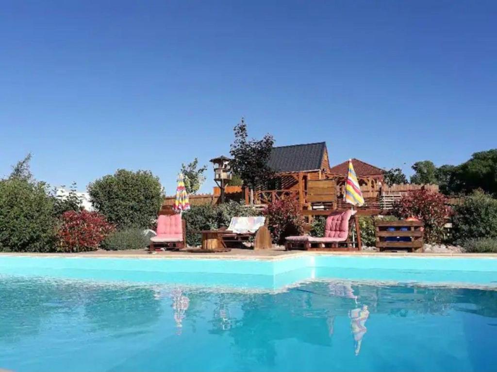 a house with a swimming pool in front of it at Du poil à la plume in Saint-Mards-en-Othe