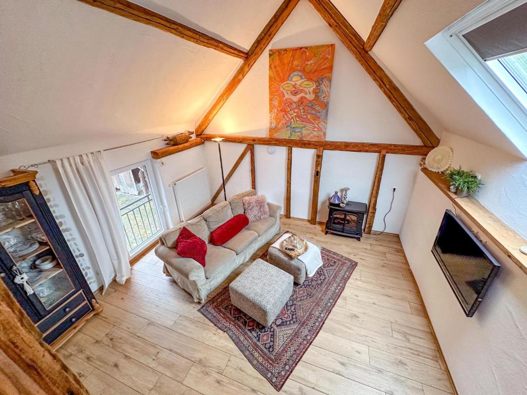 an attic room with a couch and a fireplace at Harreshof in Roes