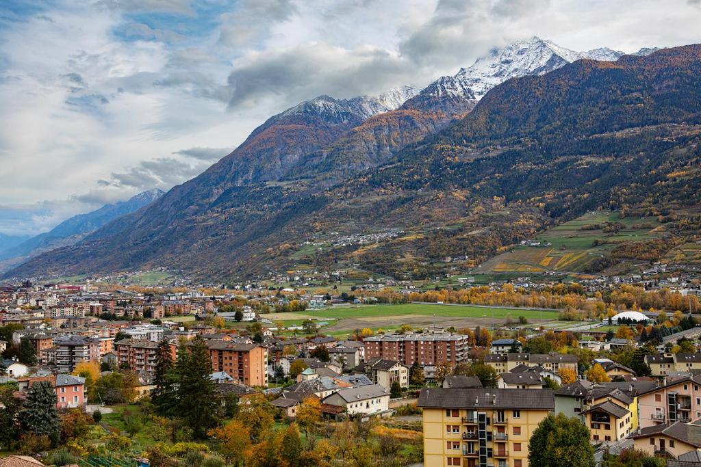 a city with mountains in the background with a town at Mon grenier in Aosta