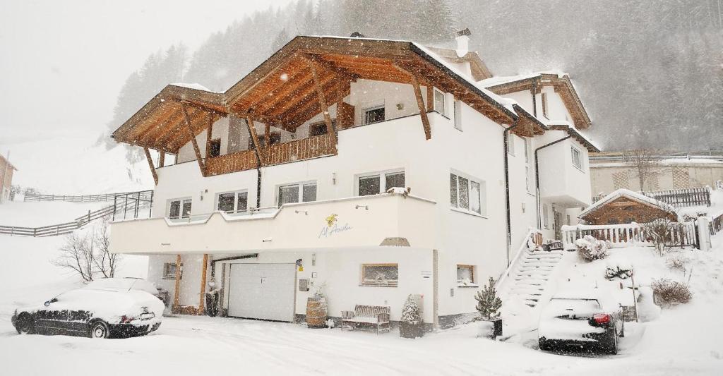 a house in the snow with snow at Apart Al-Aviöler in Ischgl