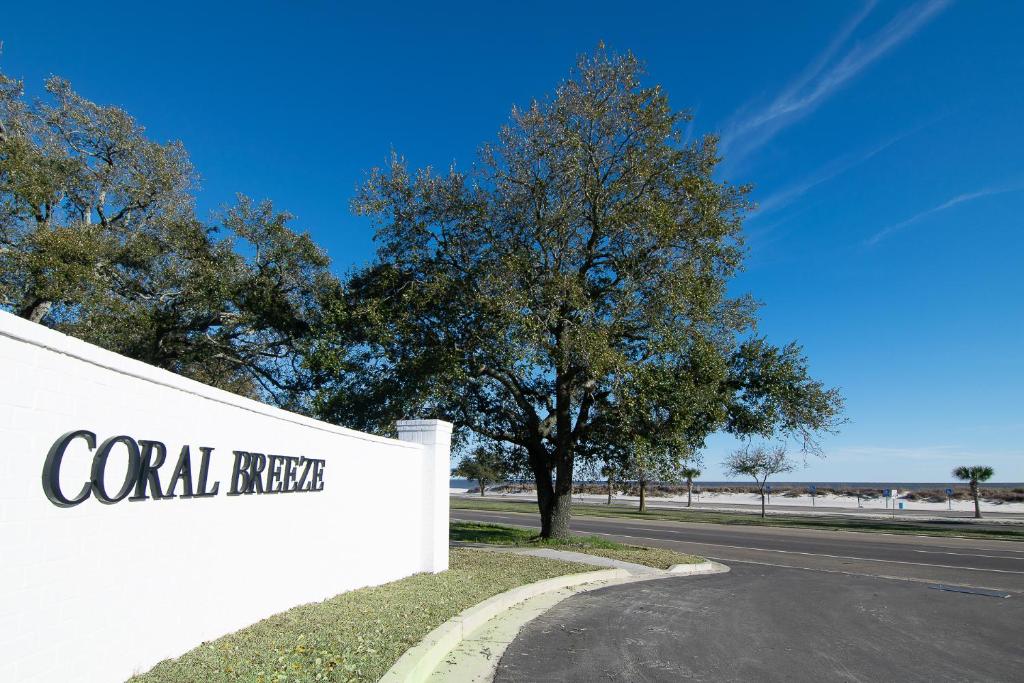 a wall with a sign that reads coral reef at Stylish, BRAND NEW 3 Bed Cottage, Beach Front, DOG FRIENDLY! in Beauvoir