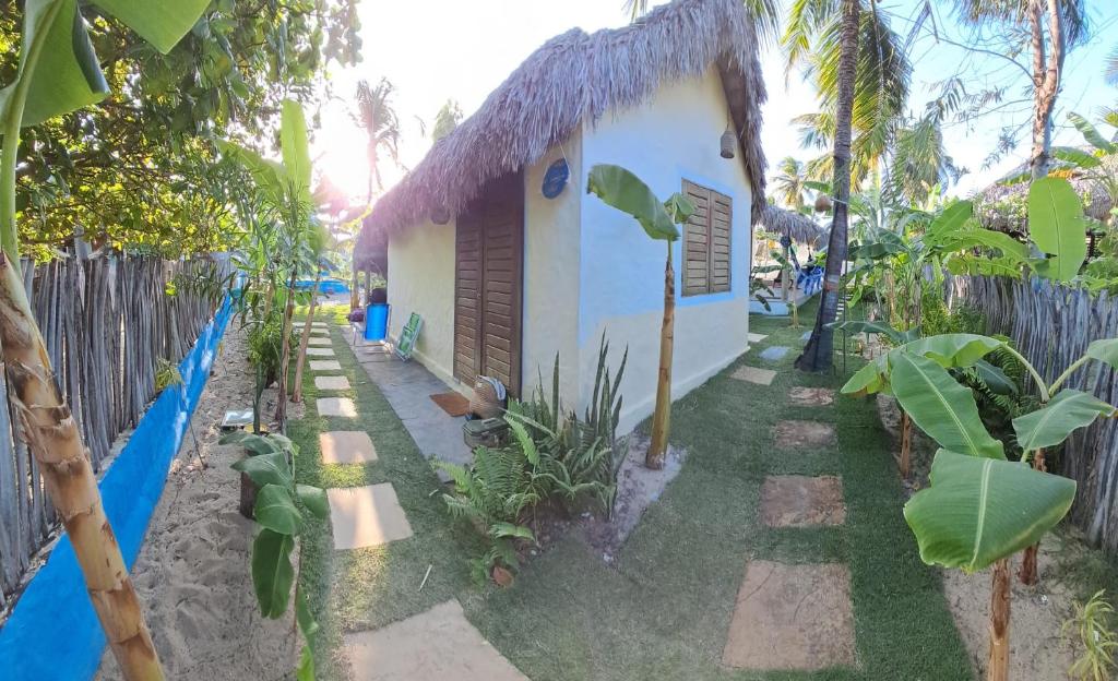 a small house with a thatched roof at Pitico - Pousada Icaraí Kite Village in Icaraí
