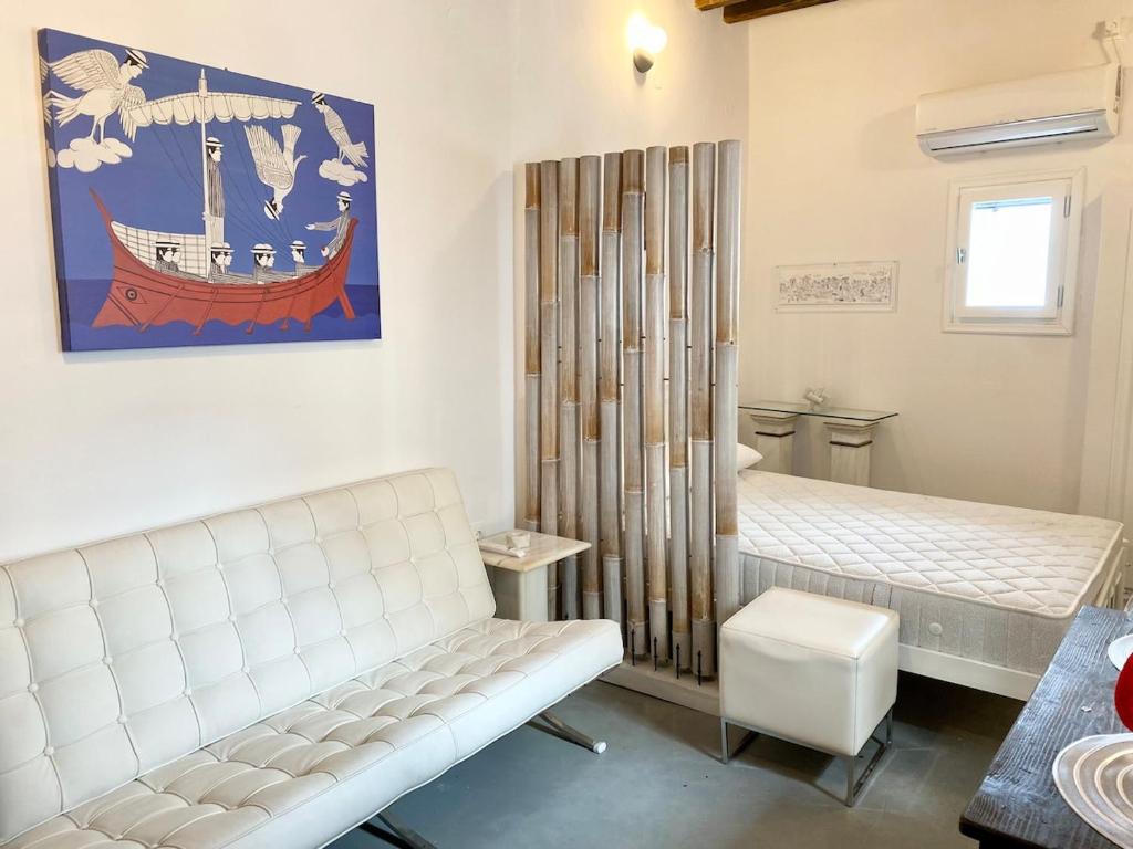 a room with a bed and a bench in it at Cyclops House in Serifos Chora