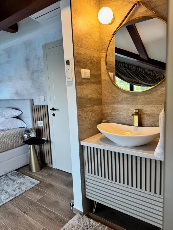 een badkamer met een wastafel en een spiegel bij Villa Venetta beach house ,Island Žirje, Šibenik in Muna