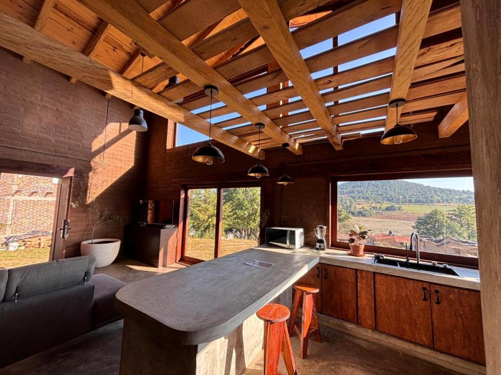 a kitchen with a counter top and a large window at Cabaña Alua in Ferrería de Tula