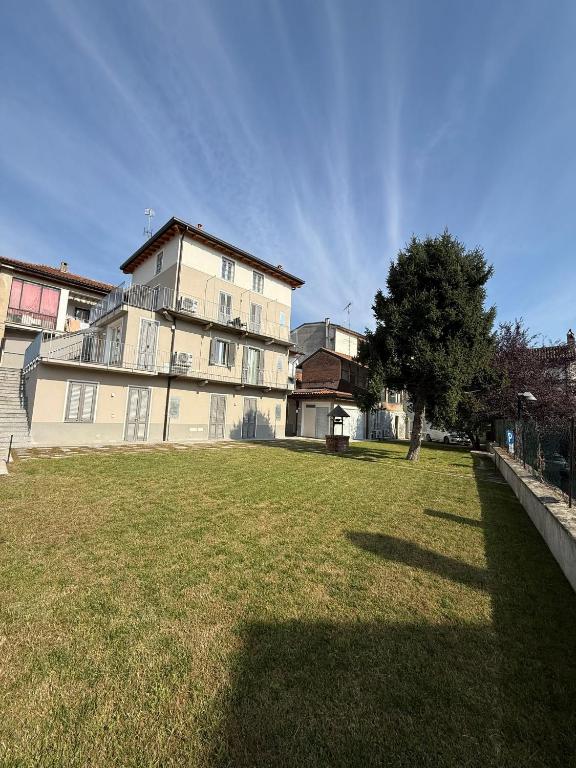 a large house with a tree in the yard at Riverwell in Sesto Calende