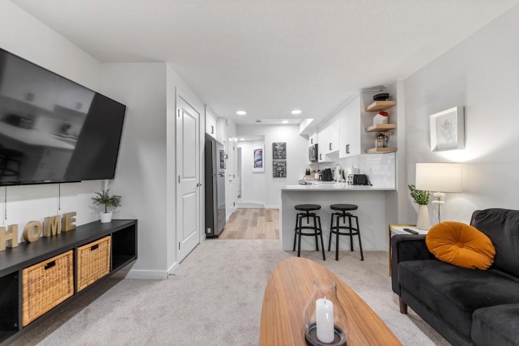 a living room with a couch and a tv at Cozy 2-Bed 1 Bath Entire Place in Calgary