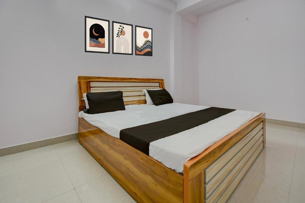 a bedroom with a wooden bed in a room at HOTEL O AS PALACe in Lucknow