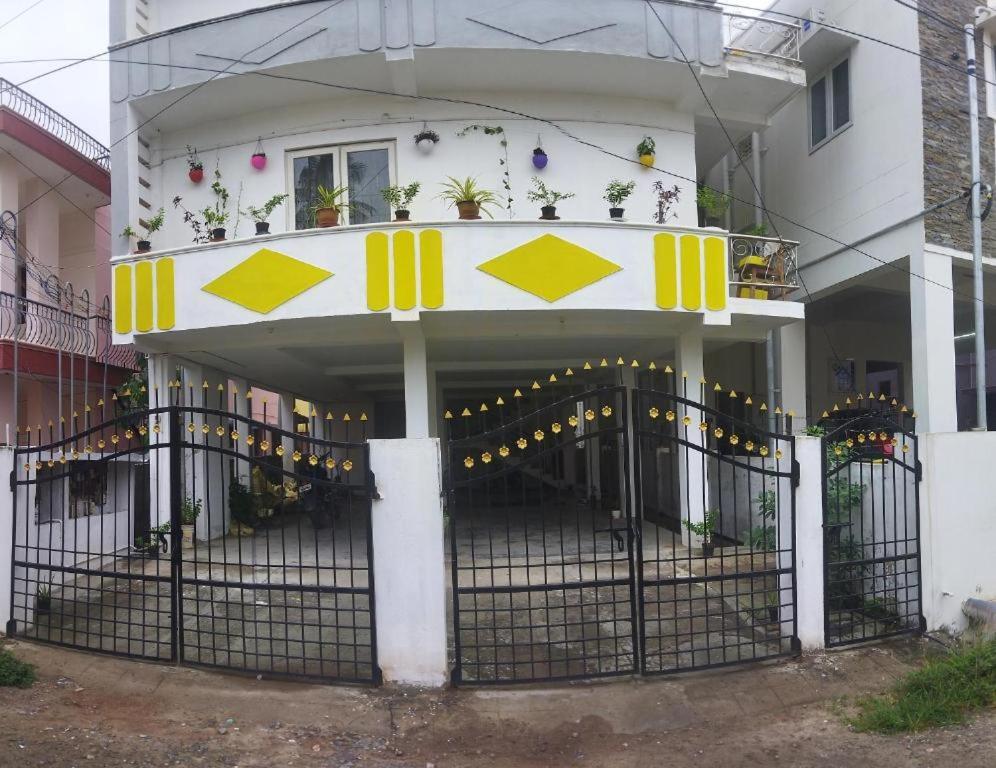 a house with a gate in front of it at WooLiv in Coimbatore
