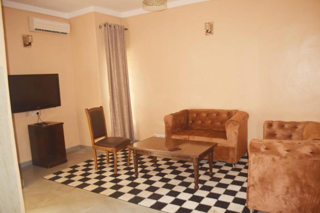 a living room with a couch and a table at Symphony Chalets 