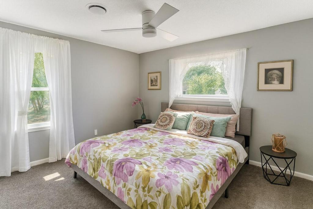 a bedroom with a bed and two windows at Modern Lux 3BR King Bed in Copperas Cove