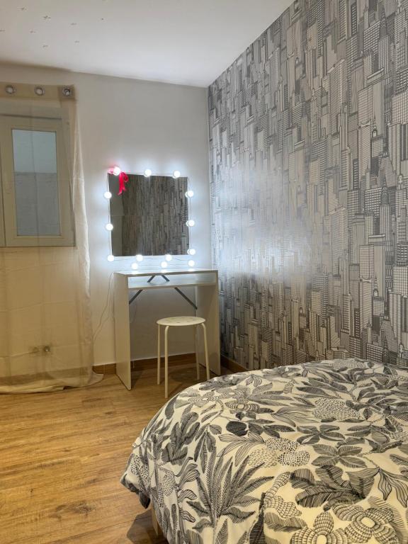 a bedroom with a bed and a desk and a mirror at Yamohome in Brussels