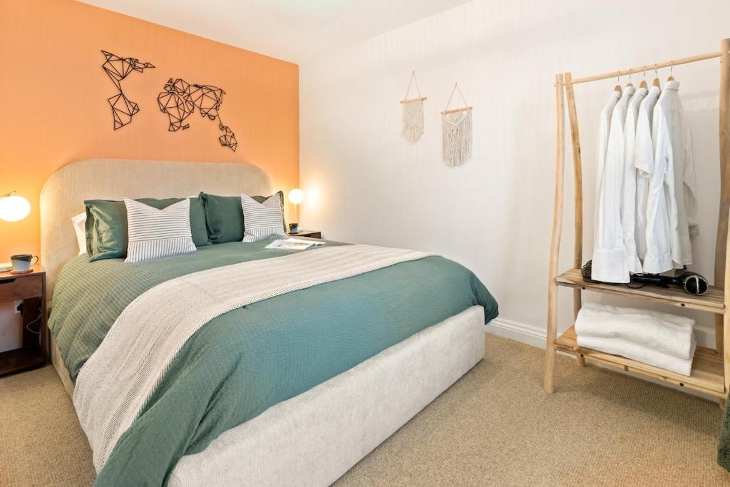 a bedroom with a large bed in a room at Stylish cosy retreat with private parking in Penryn