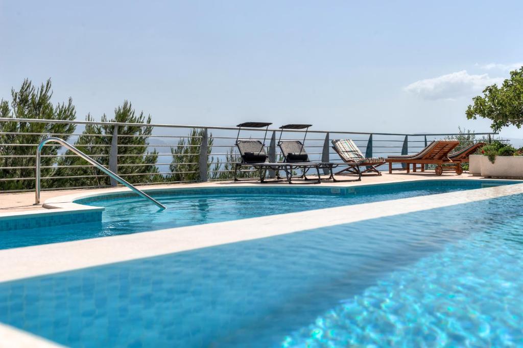 a swimming pool with a view of the water at Apartments Majda in Lokva Rogoznica