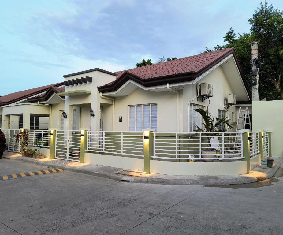 a house with a fence in front of it at Casa Thea Cebu in Talisay