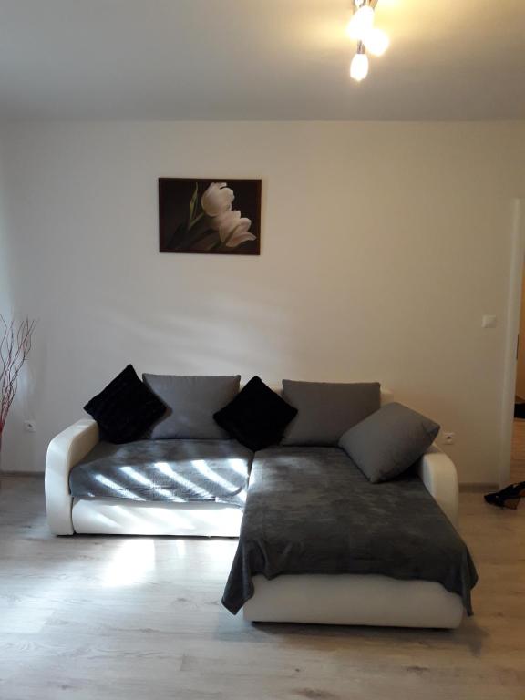 a living room with a white couch in a room at Sv & Angel Apartment in Banská Bystrica