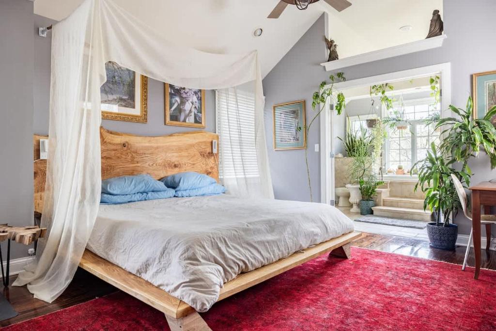 een slaapkamer met een hemelbed en een rood tapijt bij Unique Luxury Central Historic Landmark Home in Lambertville