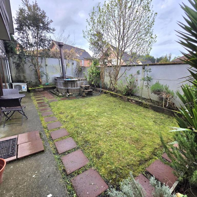 a backyard with a garden with a fire pit at Acogedora Casa con Tinaja y Jacuzzi y RENT A CAR in Puerto Varas