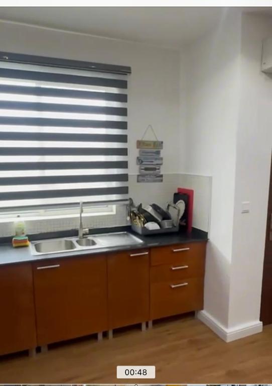 a kitchen with a sink and a window at The Manor in Ikoyi