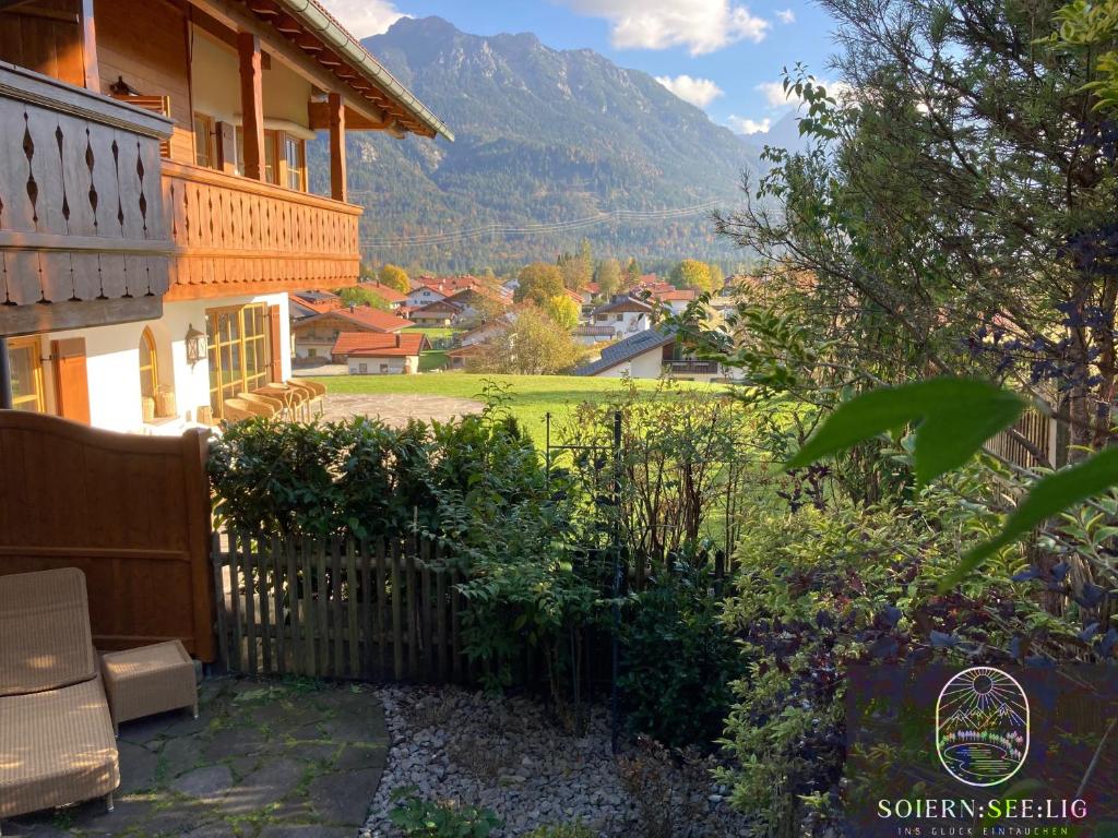a view of a house with a fence and a yard at Ferienwohnung Soiernseelig in Wallgau