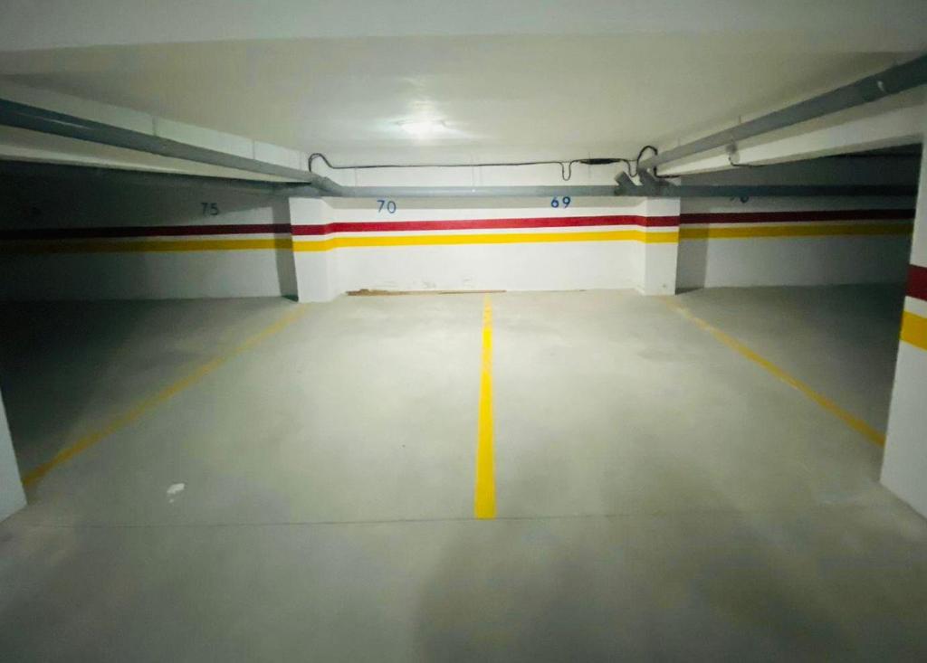 un garage vide avec une ligne jaune sur le sol dans l'établissement 1CH & Salon,climatiseur-fibre optique-gare TGV 2min de la corniche malabata, à Tanger