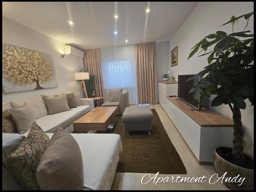 a living room with a couch and a tv at Apartment Andy in Medvode