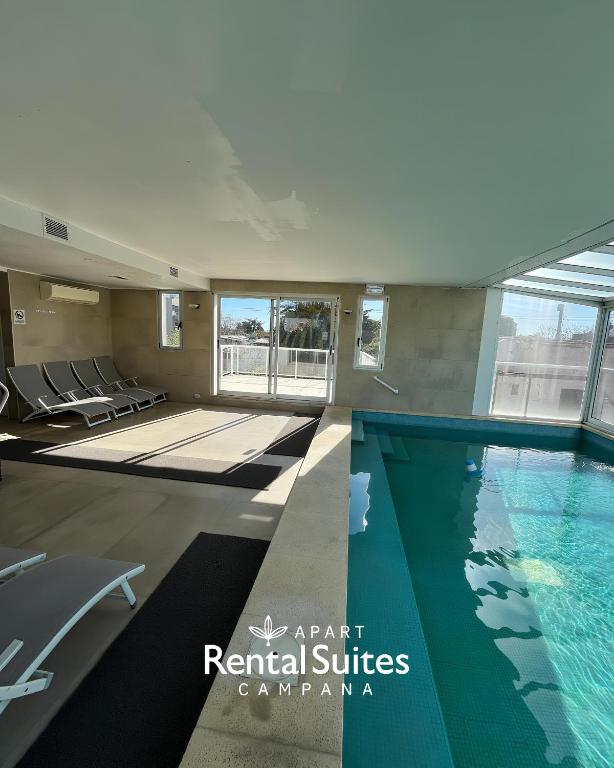 a swimming pool in a building with a swimming pool at RENTAL SUITES CAMPANA in Campana