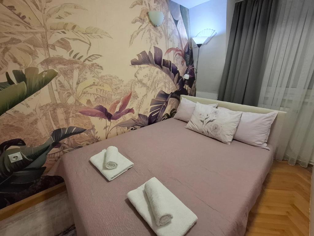 a small bedroom with a bed with two pillows on it at Apartment 88 SELF check-in, FREE parking in Skopje