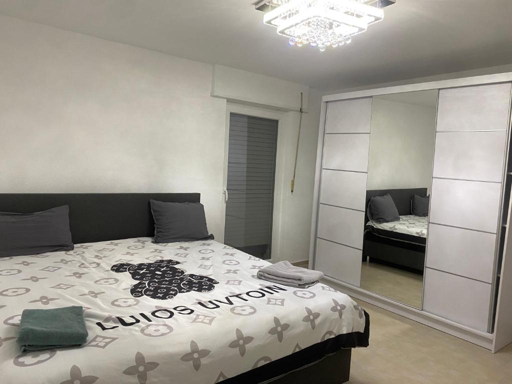 a bedroom with a bed and a mirror at 3 zimmer Apartment in Lörrach