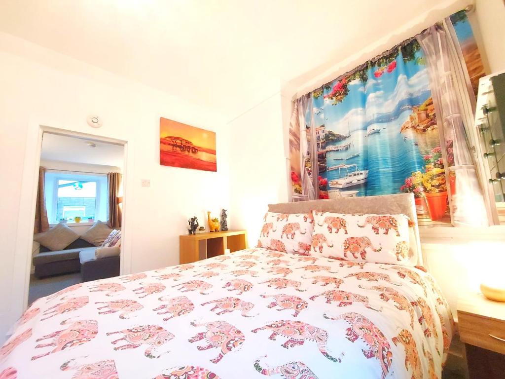 a bedroom with a bed and a large window at The Wee Nest in Largs - One-Bedroom Ground Flat in Largs