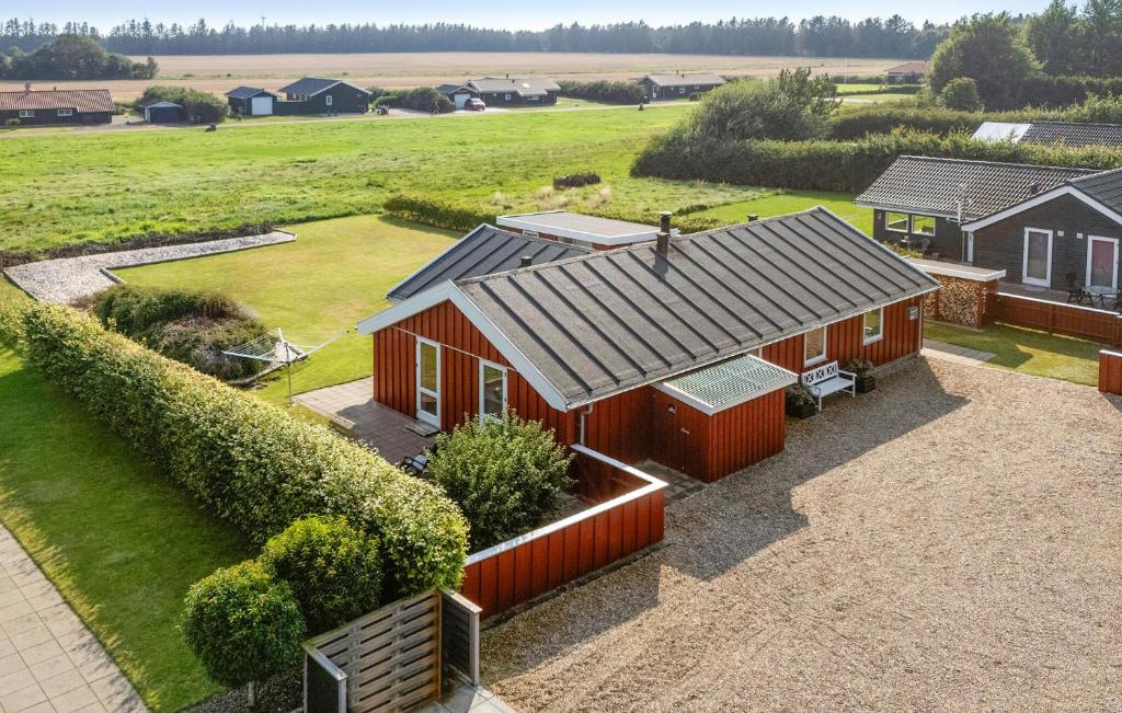 an aerial view of a red house with a yard at Nice Home In Tarm With Sauna in Højsand