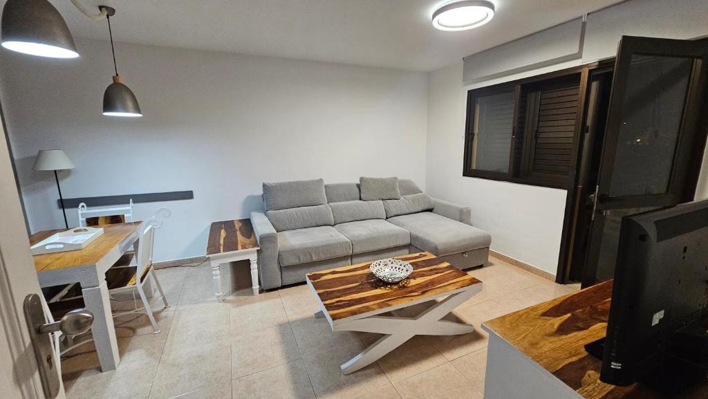 a living room with a couch and a table at Casa Galena in Corralejo