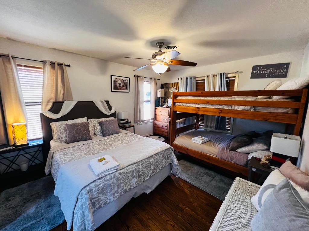 a bedroom with two beds and a ceiling fan at Lakefront Getaway in Lone Oak