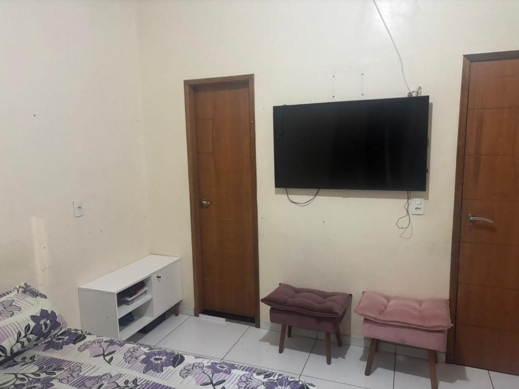 a bedroom with a flat screen tv on the wall at Marco in Belém