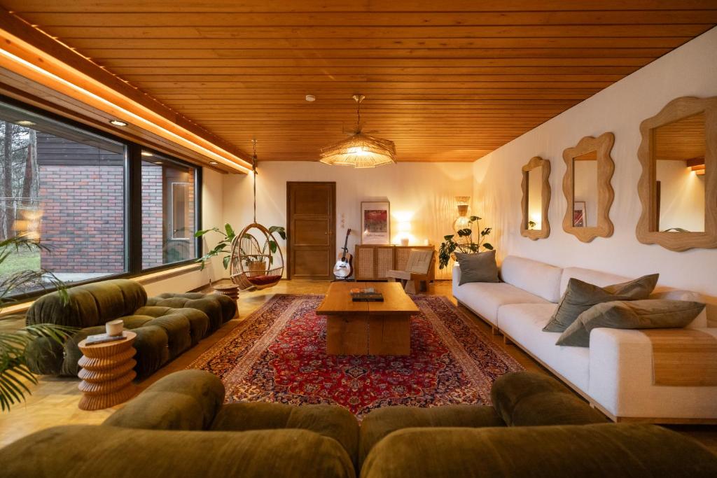 a living room with a couch and a table at Villa Amara & Private Spa in Rovaniemi