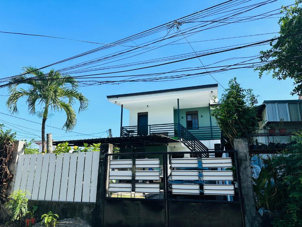 a house with a staircase in front of a fence at Bloom&Blossom in Iloilo City