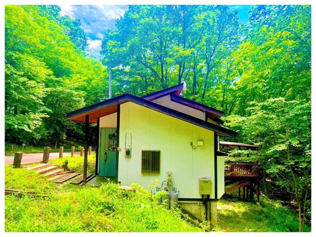 a small house in the middle of a forest at コテージちゃ豆ん家 in Nasu