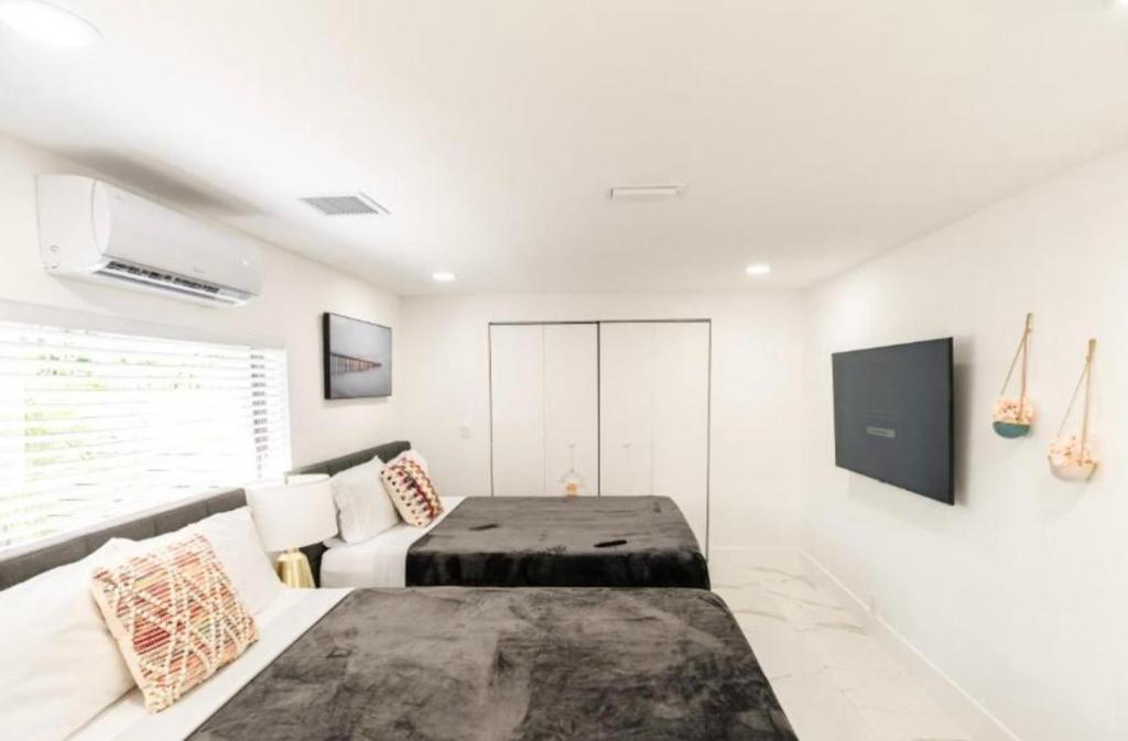 a white bedroom with a bed and a couch at Viva La Villa in Highland Lakes