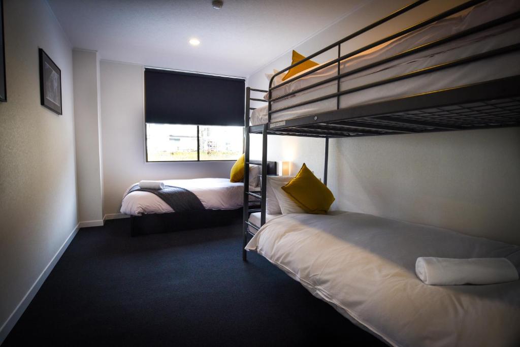 a bedroom with two bunk beds and a window at The Phat Palace in Otari