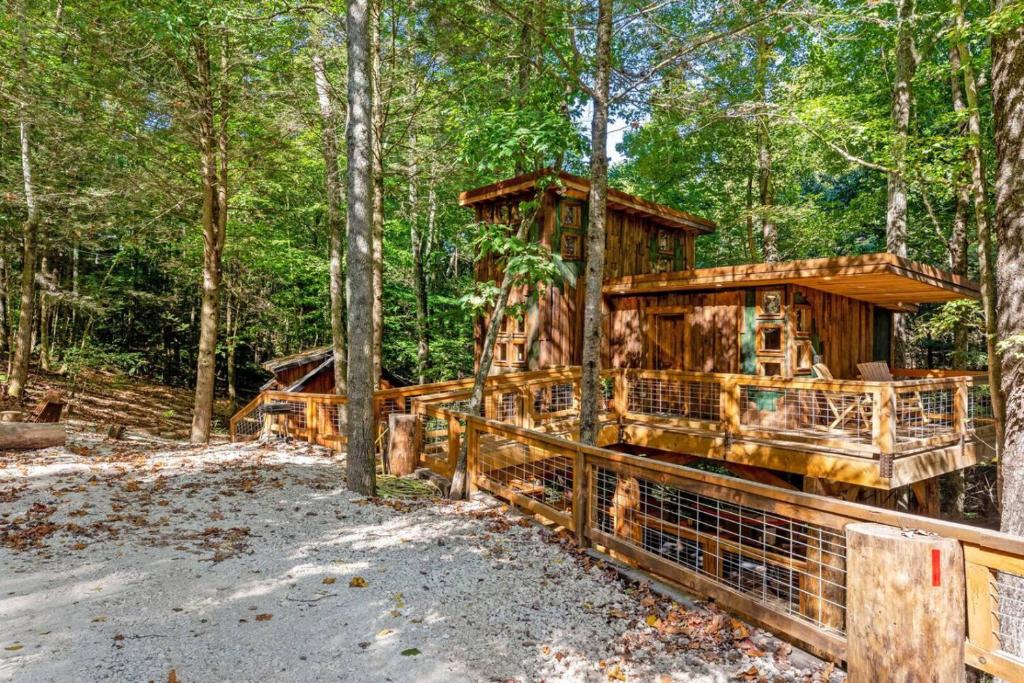 a tree house in the woods with a fence at Treehouse - Amazonia - Red River Gorge KY in Rogers