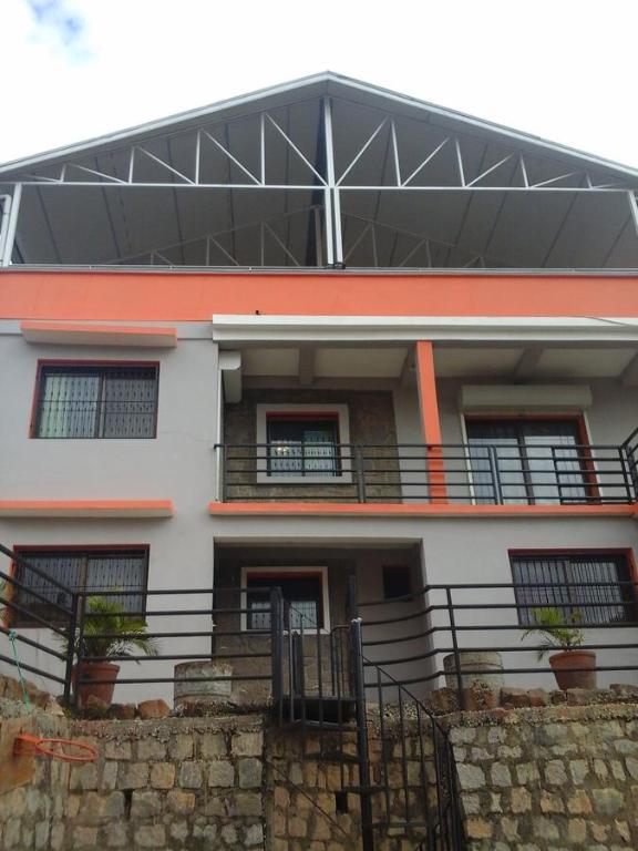 a white building with a balcony with plants on it at Tanana Maeva in Antananarivo