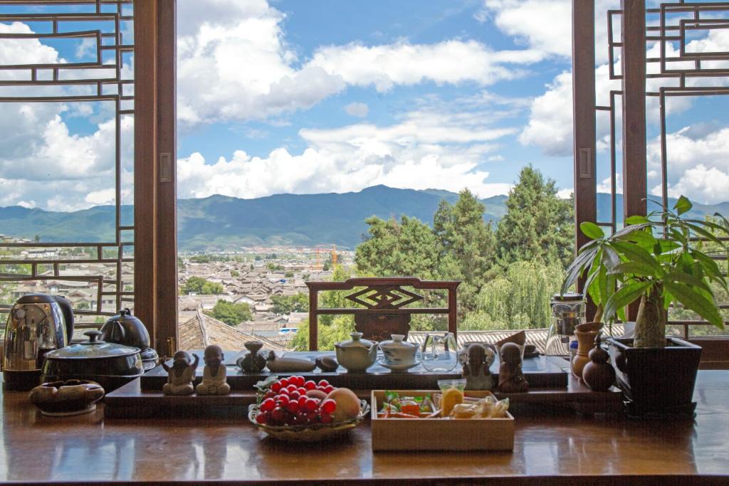 a room with a table with a view of a city at Lijiang Merry Inn in Lijiang