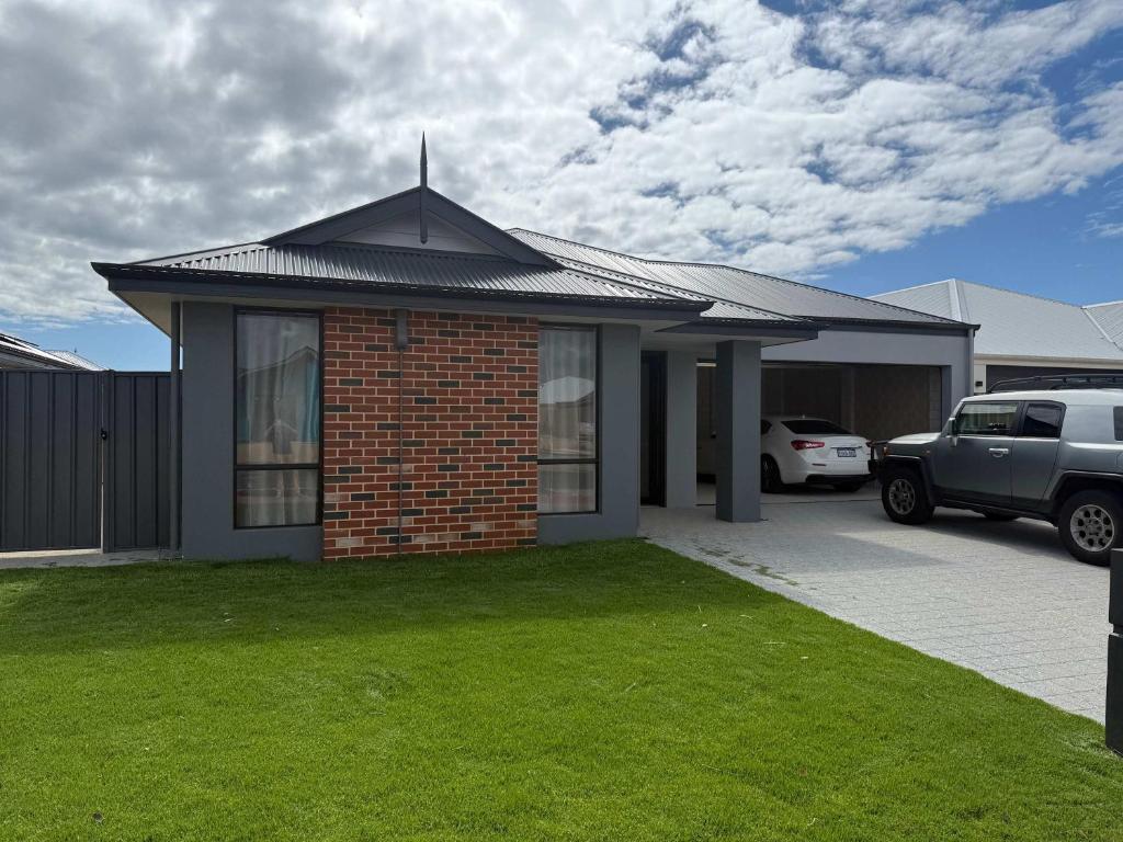 a brick house with a car parked in a driveway at Milbridge Getaway with a bathroom in each room in Eaton